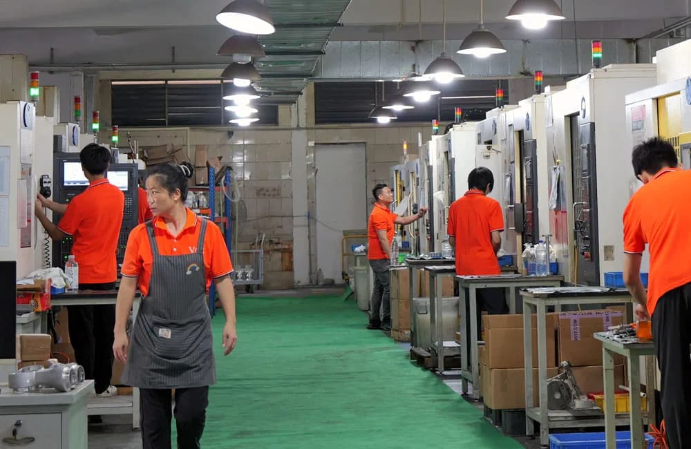 VOGUC production team operating CNC machines in Dongguan